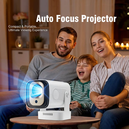 Family sitting in a living room with a Magcubic HY310 Auto Focus Projector on a table.
